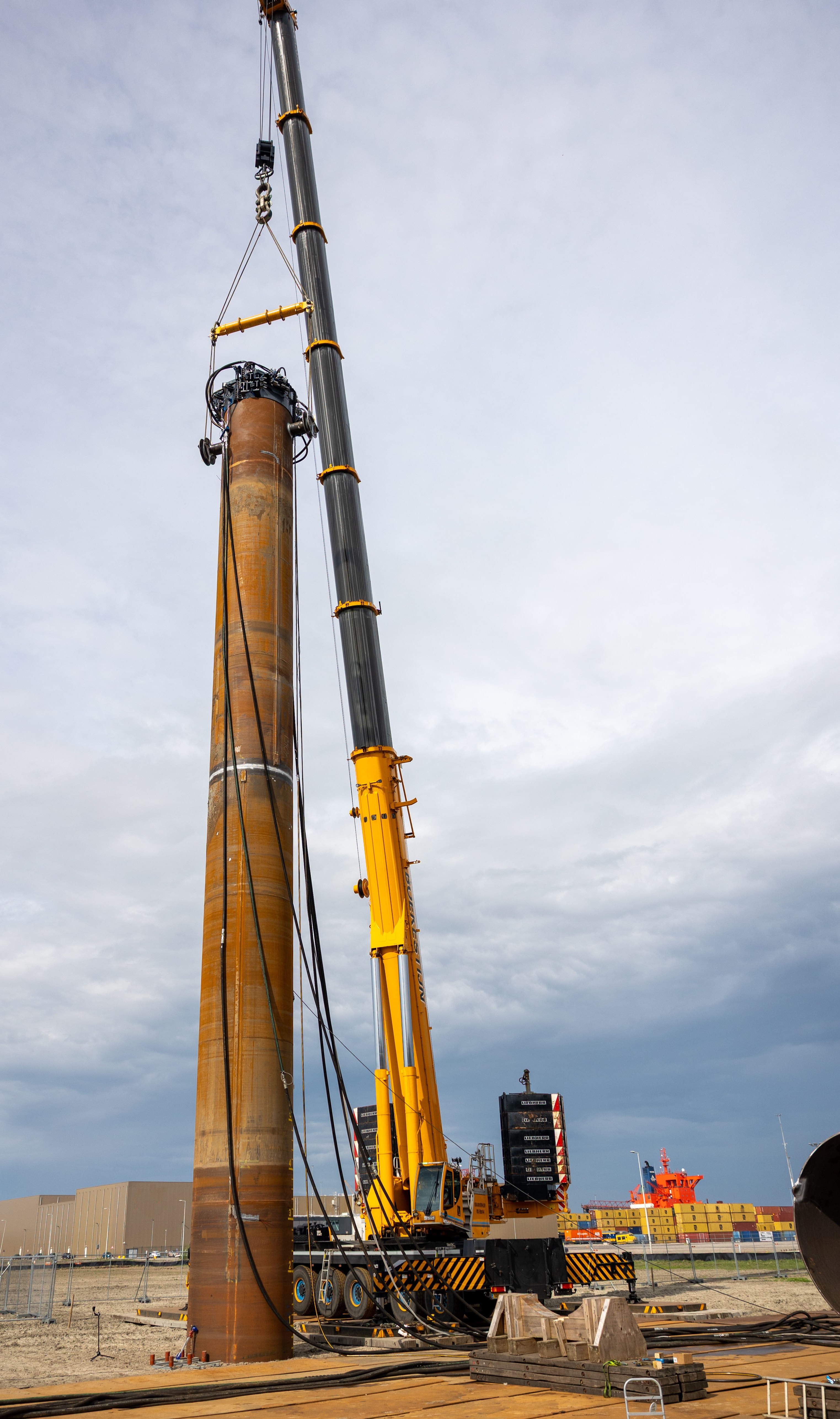 The pile just before the drill, with a crane next to it.